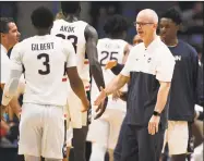  ?? Jessica Hill / Associated Press ?? UConn coach Dan Hurley greets Alterique Gilbert during a timeout in the first half of an October exhibition game in Hartford.