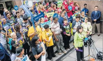  ?? Marcus Yam
Los Angeles Times ?? L.A. COUNTY SUPERVISOR Hilda Solis joined fellow supervisor­s Mark Ridley-Thomas and Sheila Kuehl in the majority approving the wage raise. Above, Solis stands with backers of a wage hike outside the county hall.