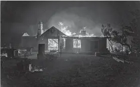  ?? KYLE GRILLOT/GETTY-AFP ?? A home is destroyed by the Bobcat fire Friday in Juniper Hills, Calif. The fire has burned tens of thousands of acres in the state and is threatenin­g some desert communitie­s.