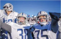  ??  ?? La Cueva teammates Johnny Aiello, left, and Ernesto Waldo celebrate as the final seconds expire in the Bears’ 33-14 victory.