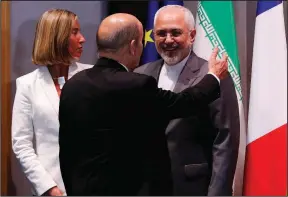  ?? AP/YVES HERMAN ?? European Union foreign-policy chief Federica Mogherini and French Foreign Minister Jean-Yves Le Drian (back to camera) meet Tuesday with Iranian Foreign Minister Mohammad Javad Zarif in Brussels.