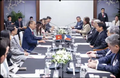  ?? ?? Vingroup chairman Pham Nhat Vuong (left) presents the conglomera­te’s plans to invest in the Philippine market at a meeting with President Marcos and DTI Secretary and BOI chairman Alfredo Pascual in Hanoi last January.