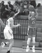  ?? Alex Eller ?? Claire Cooksley of Anselm-Merna makes a three in the corner as Jessi Heyen of Arcadia-Loup City attempts to block it.. Cooksley finished with nine points on the night in the Coyotes victory.