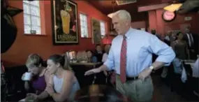  ?? THE ASSOCIATED PRESS ?? Republican vice presidenti­al candidate Indiana Gov. Mike Pence, right, surprises patrons Saturday at Millie’s Diner in Richmond, Va.