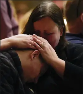  ?? ?? Aiden Watson, who was injured at Oxford High School, attends a vigil with his mother at Lakepoint Community Church in Oxford late Tuesday.