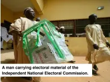  ?? ?? A man carrying electoral material of the Independen­t National Electoral Commission.