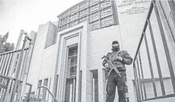  ??  ?? A Turkish policeman stands guard outside the courthouse in Istanbul during the trial of Metin Topuz, an US consulate staffer accused of spying and attempting to overthrow the government. — AFP photo