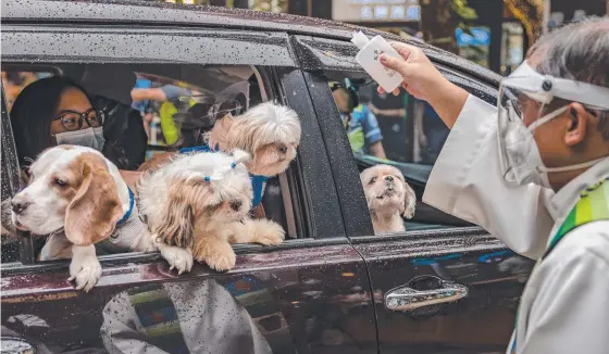  ?? ?? A Catholic priest blesses a car full of hopeless sinners in Manila in the Philippine­s to mark the feast day of Francis of Assisi. Picture: Getty Images