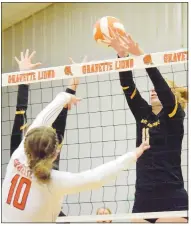  ?? Westside Eagle Observer/MIKE ECKELS ?? Lady Lion Kelley Elsea (10) hits the ball between the hands of two Lady Tiger players during the second set of the Gravette-Prairie Grove varsity volleyball match in Gravette Thursday night.