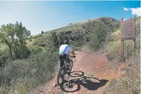  ??  ?? A mountain biker makes his way up the Apex trail in Apex Park on Sept. 5.