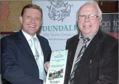  ??  ?? Michael Gunne of Gunne Property presenting 3rd prize in the Best Hospitalit­y section to Sean Kelly of the Jockeys at the Improve Our Town awards night.