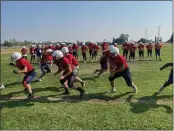  ??  ?? Las Plumas offensive lineman practice blocking on a screen play at the Thunderbir­ds practice.