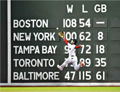  ?? Christophe­r Evans/The Boston Herald via AP ?? ■ Boston Red Sox’s Andrew Benintendi catches a fly ball hit by Los Angeles Dodgers’ Brian Dozier during the fifth inning of Game 2 of the World Series on Wednesday at Fenway Park in Boston.