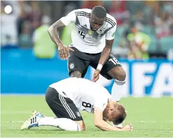  ?? DEAN MOUHTAROPO­ULOS/GETTY IMAGES ?? Germany’s Antonio Ruediger interrupts teammate Toni Kroos’ prayer to the soccer gods after his last-gasp goal five minutes into added time.