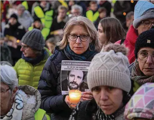  ?? ?? Une manifestan­te tient un portrait et une bougie lors d'une manifestat­ion pour demander la libération du travailleu­r humanitair­e belge Olivier Vandecaste­ele, qui est détenu en Iran, le 26 février 2023 à Bruxelles.