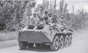  ?? IRYNA RYBAKOVA VIA AP ?? UKRAINIAN soldiers ride an APC on the frontline near Bakhmut, the site of fierce battles with the Russian troops in the Donetsk region, Ukraine on Monday, June 5, 2023.