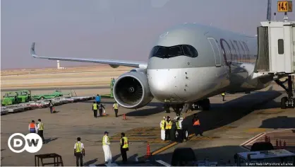  ??  ?? Saudi airport officials surround the first Qatar Airways plane in three years to land in Riyadh