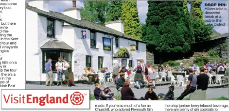  ??  ?? DROP INN: Hikers take a deserved break at a pub in the Lake District