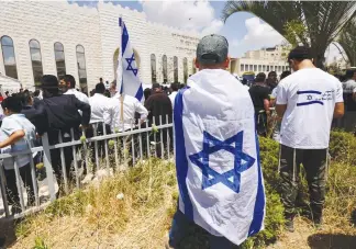  ?? (Ronen Zvulun/Reuters) ?? MOURNERS AT the funeral of Yonatan Havakuk and Boaz Gol, in Elad on Friday.