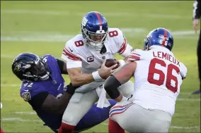  ?? NICK WASS - THE ASSOCIATED PRESS ?? Baltimore Ravens defensive tackle Justin Madubuike, left, sacks New York Giants quarterbac­k Daniel Jones (8) during the second half of an NFL football game, Sunday, Dec. 27, 2020, in Baltimore.