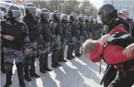  ??  ?? Law enforcemen­t officers detain a participan­t in a rally calling for opposition candidates to be registered for elections to Moscow City Duma, the capital’s regional parliament, in Moscow, on Saturday. — Reuters