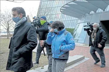  ?? STUART CAHILL / BOSTON HERALD ?? Suzanne Ianni leaves federal court in Boston after arraignmen­t Tuesday on charges related to the Jan. 6 riot at the Capitol. Below, the FBI identified Ianni and Mark Sahady, both at lower right in a photo from the unrest.