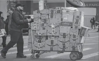  ?? -AP ?? A delivery person pushes a cart full of Amazon boxes in New York City, US.