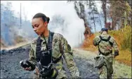  ?? TAO XIYI / XINHUA ?? Two soldiers monitor the concentrat­ion of sulfur dioxide during ongoing eruptions of the Kilauea Volcano in Hawaii on Wednesday.