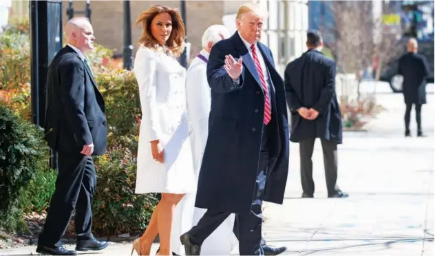  ?? ASSOCIATED PRESS ?? ↑ TRUMP AND MELANIA WALK TO THEIR MOTORCADE AFTER ATTENDING CHURCH IN WASHINGTON ON SUNDAY.