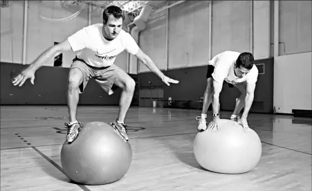  ?? By Nancie Battaglia for USA TODAY ?? Balancing act: Christian Niccum, left, and Patrick Quinn work with rubber balls during a morning workout. Competitio­n begins Nov. 5-6 in Latvia.