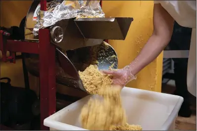  ?? ?? Leslie Lopez grinds corn for masa Dec. 3 at South Philly Barbacoa.