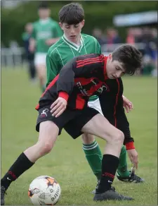  ??  ?? Seanie O’Brien Murphy of Gorey Rangers holds off the challenge of Luke Kavanagh of Forth Celtic.