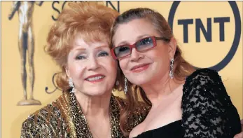  ??  ?? DOUBLE ACT: Actress Debbie Reynolds with her daughter actress Carrie Fisher backstage after accepting her Lifetime Achievemen­t award at the 21st annual Screen Actors Guild Awards in Los Angeles, California, last January. Debbie Reynolds died,...
