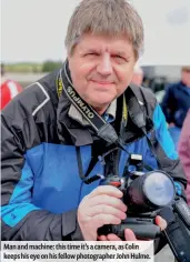  ??  ?? Man and machine: this time it’s a camera, as Colin keeps his eye on his fellow photograph­er John Hulme.