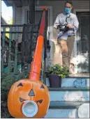 ?? Erin Hooley Chicago Tribune ?? Liam Ford decorates his porch and Halloween treat chute.