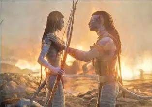  ?? COURTESY 20TH CENTURY STUDIOS/TNS ?? Neytiri (Zoe Saldana), left, and Jake Sully (Sam Worthingto­n) appear in a scene from “Avatar: The Way of Water.”