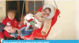  ?? ?? Afraa al-Sawadi sits in a swing at her uncle’s house.