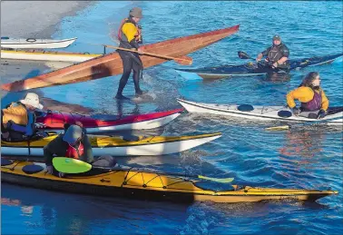  ?? SARAH GORDON/THE DAY ?? A group of kayakers with the Tuesday Night Paddle group launch on Tuesday from Eastern Point Beach in Groton. The group is based in Groton and gathers every Tuesday evening at a different spot along the Connecticu­t coast from Old Saybrook to Stonington.