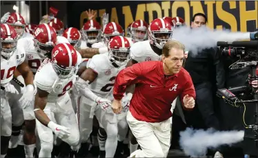  ?? Associated Press ?? No. 1: Alabama head coach Nick Saban leads his team on the field before the NCAA college football playoff championsh­ip game against Georgia, in Atlanta. The AP preseason Top 25 is out, and for the third straight year Alabama is No. 1.