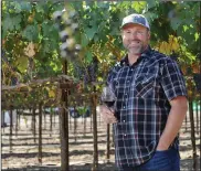  ?? BEA AHBECK/ NEWS-SENTINEL ?? Adam Mettler, director of wine operations for Michael David Winery, stands in the vineyard in Lodi on Thursday. He was nominated for Wine Enthusiast’s 2018 Wine Star Award for Winemaker of the Year.