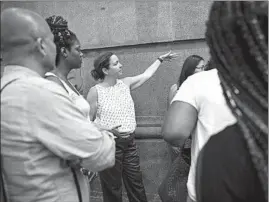  ??  ?? Chicago Riverwalk Project Manager Michelle Woods gives a tour of future available vendor locations west of Michigan Avenue to a group of business owners Wednesday.