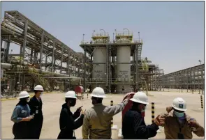  ??  ?? Saudi Aramco engineers and journalist­s look at the Hawiyah Natural Gas Liquids Recovery Plant, which is designed to process 4.0 billion standard cubic feet per day of sweet gas, a natural gas that does not contain significan­t amounts of hydrogen sulfide, in Hawiyah, in the Eastern Province of Saudi Arabia. (AP/Amr Nabil)