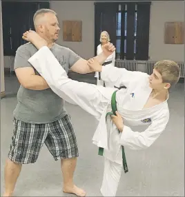  ?? ADAM MACINNIS/THE NEWS ?? Maddox Fields demonstrat­es a kick with his dad Jason at the New Glasgow Karate Club in New Glasgow.