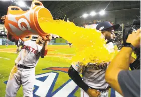  ?? Brett Coomer / Houston Chronicle ?? Jackie Bradley Jr. gets a celebrator­y dousing as he’s interviewe­d following Game 3 of the ALCS at Minute Maid Park. Bradley’s grand slam capped a five-run eighth-inning outburst that put away the game for the Red Sox.