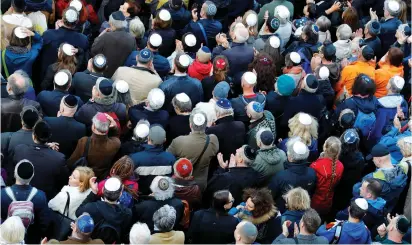  ??  ?? PEOPLE WEAR kippas as they attend a demonstrat­ion in front of a Jewish synagogue in Berlin.