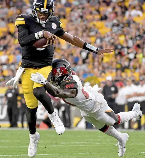  ?? Matt Freed/ Post- Gazette ?? Quarterbac­k Josh Dobbs carries for a first down against Buccaneers safety Kentrell Brice in the second quarter Friday at Heinz Field. The Steelers largely struggled on the ground, and Dobbs finished as the leading rusher with 44 yards.