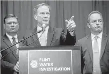  ?? Jake May / Flint Journal-MLive.com via Associated Press ?? Michigan Attorney General Bill Schuette announces Friday that six more state employees are charged with misconduct and other crimes in connection with the Flint water crisis.