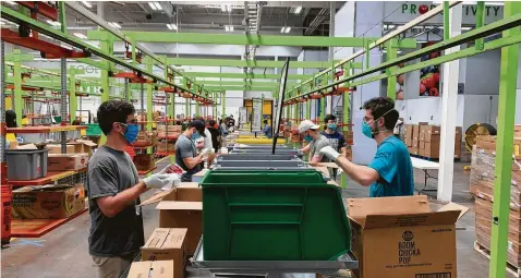  ?? Courtesy / Houston Food Bank ?? With demand skyrocketi­ng, Houston Food Bank officials say they have doubled distributi­ons, now up to 1 million pounds of food per day.