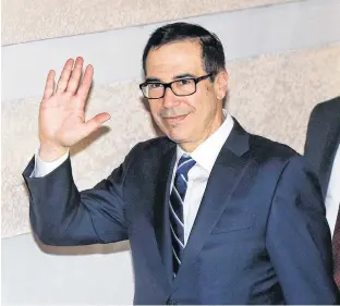  ?? AP PHOTO ?? U.S. Treasury Secretary Steven Mnuchin waves to journalist­s as he leaves the hotel in Beijing, Wednesday.