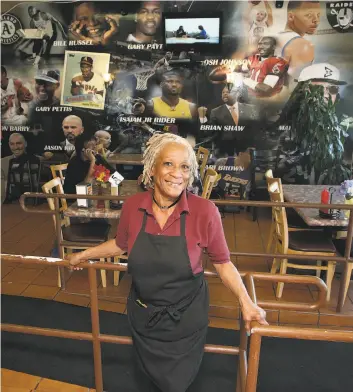  ?? Photos by Liz Hafalia / The Chronicle ?? Ms. Coffey, a.k.a. Isabella Coffey (above), at her Big Momma’s Kitchen in Oakland with its mural of Oakland sports figures. Left top: Head cook Rico Calhoun with a brisket from the restaurant smoker. Left below: Barbecue chicken and greens, with a side...